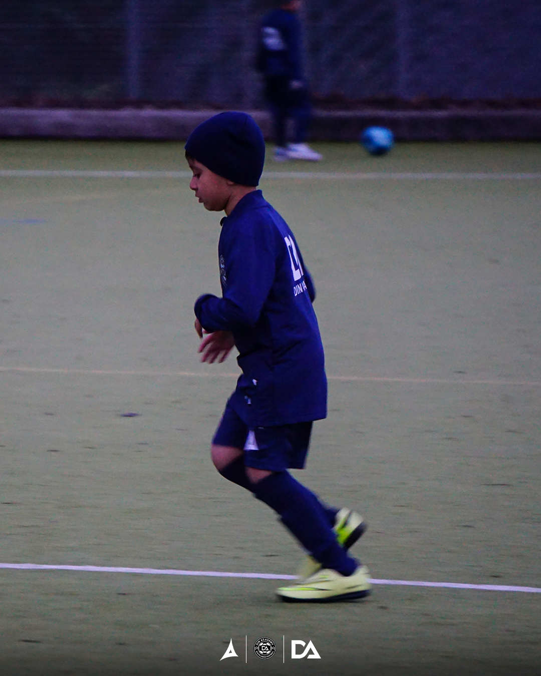 Dramatic black and white photo of a football player focused on the ball